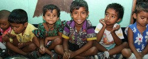 little kids sitting lined up in a row