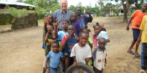 Libeeria Kids smiling with a Feeding The Nation worker