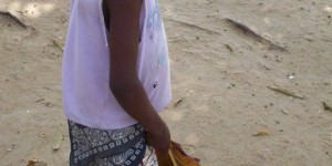 Little boy carrying giant leafs