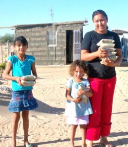 family holding bags full of food