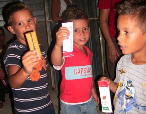 three boys holding up food