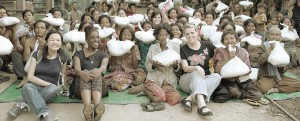 group of people holding big bags of food