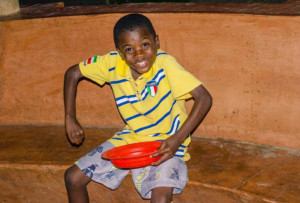 Malawi Bot Smiling and holding a bowl