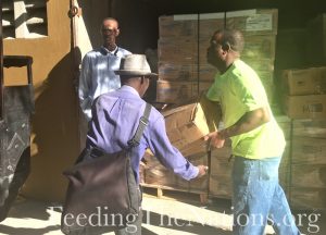 Three Men Unloading a truck