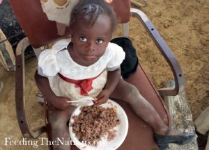 little girl with plate full of of rice and Beans s