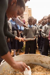 Beans and Rice being distributed to little kids