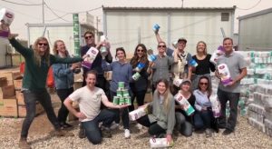 people posing with the food they will give out