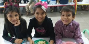 Venezuela kids with plates full of food