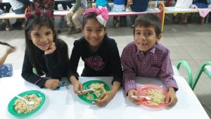 Venezuela kids with plates full of food